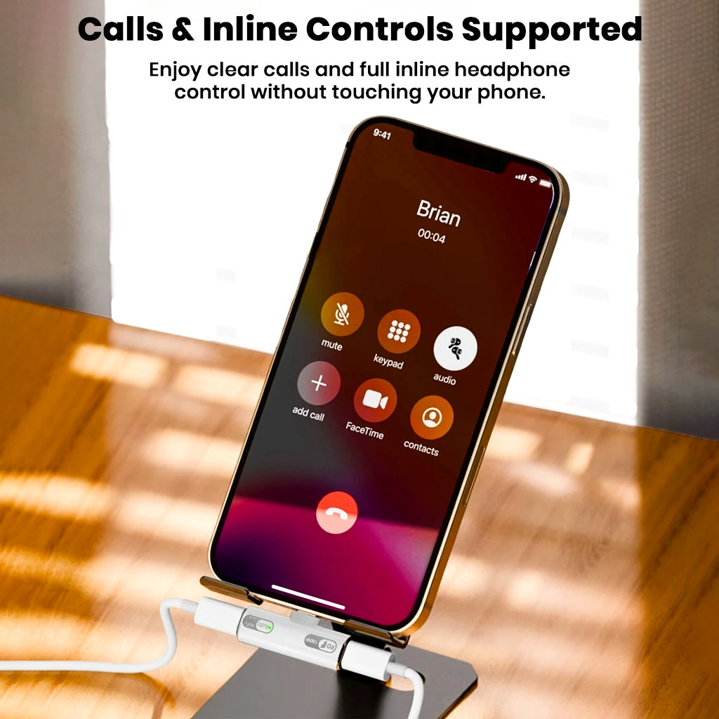 AUDIOCULAR A15X adapter supports calls and inline headphone controls, shown connected to a phone during a voice call on a stand.
