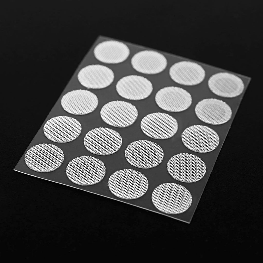 Sheet of white adhesive patches on a black background