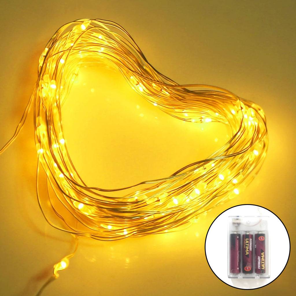 Battery Fairy Lights 10M with 100 Warm LEDs coiled in a heart shape, featuring a compact battery pack for flexible home and festive decor.