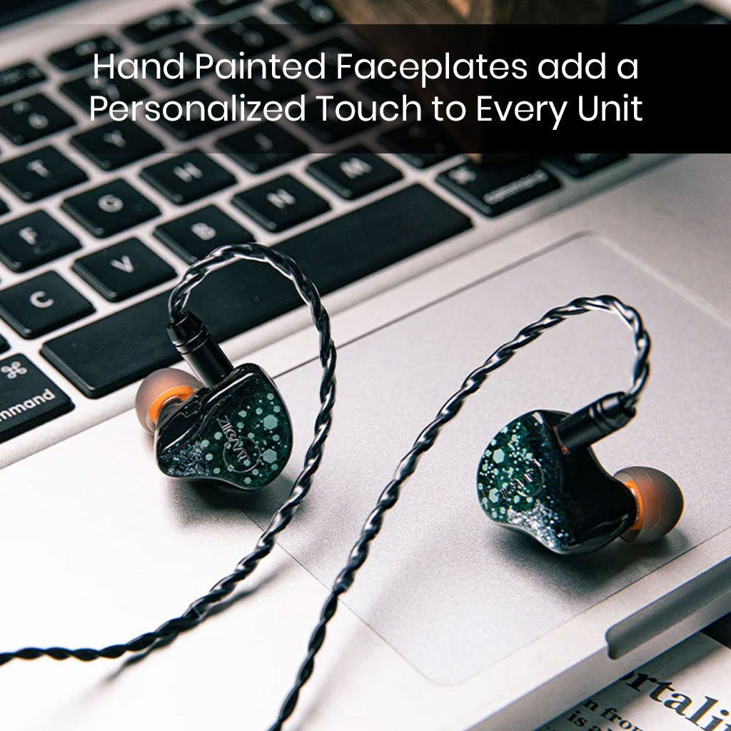 ZiiGaat Arcanis IEM with hand-painted faceplates resting on a laptop, emphasizing its artistic design and premium craftsmanship.