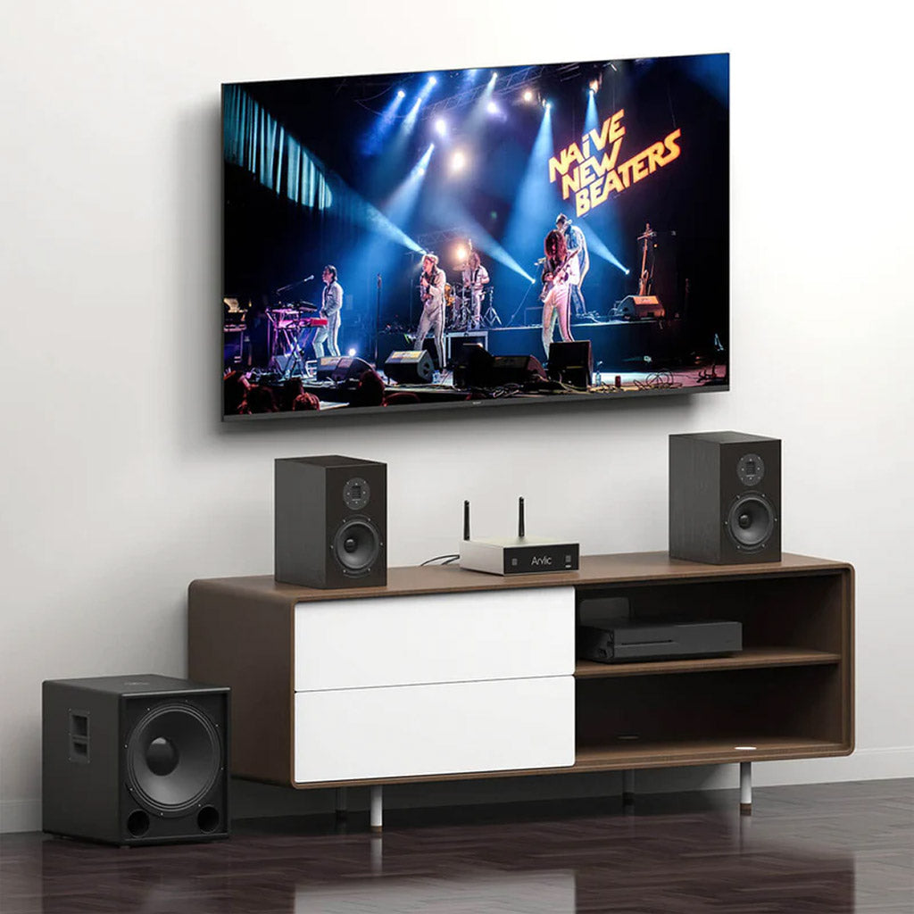 Arylic A50+ connected to a home theater system with TV, subwoofer, and stereo speakers for powerful multi-room audio performance.