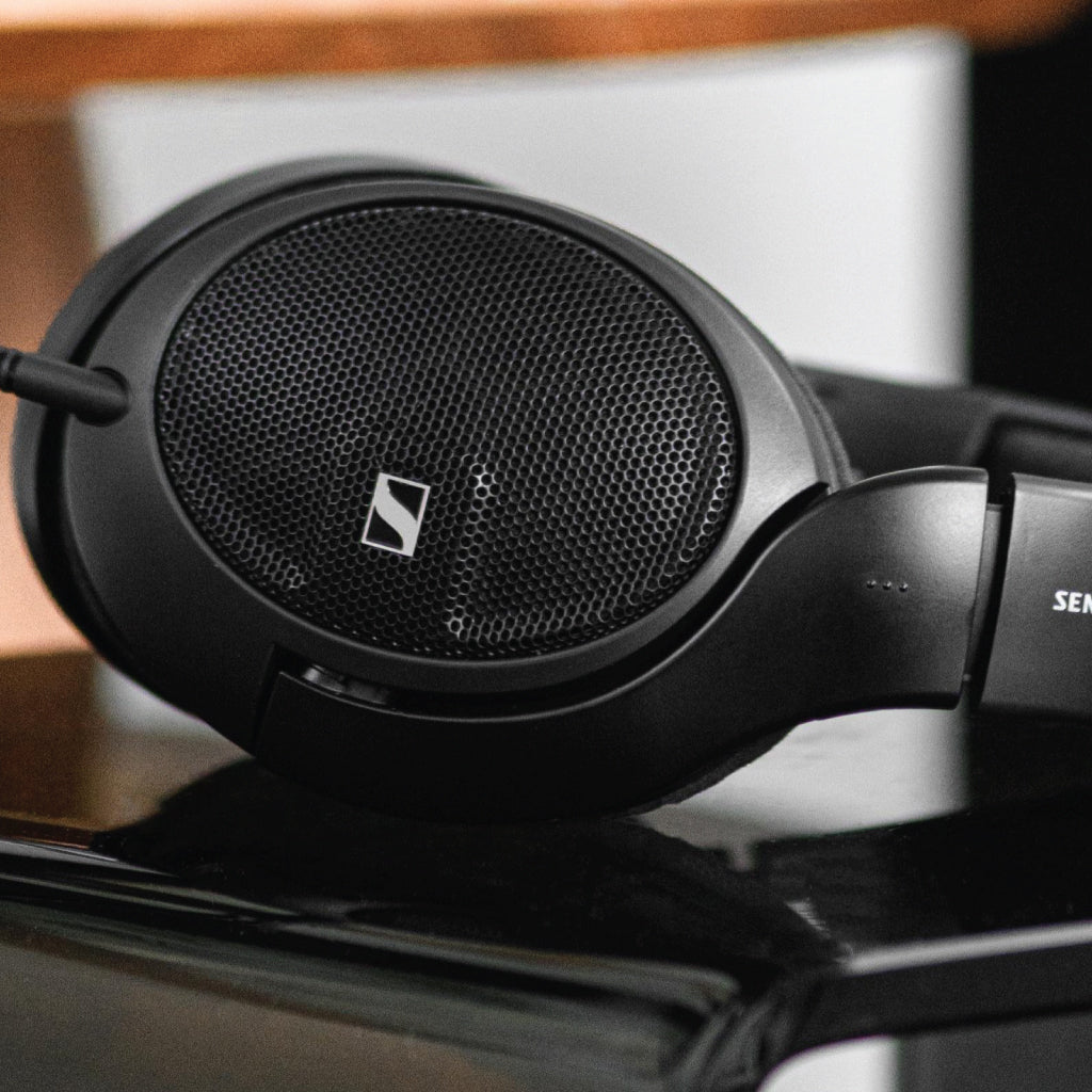 Close-up of Sennheiser HD 560S open-back headphones showcasing mesh earcup design and iconic logo, ideal for high-fidelity audio performance.