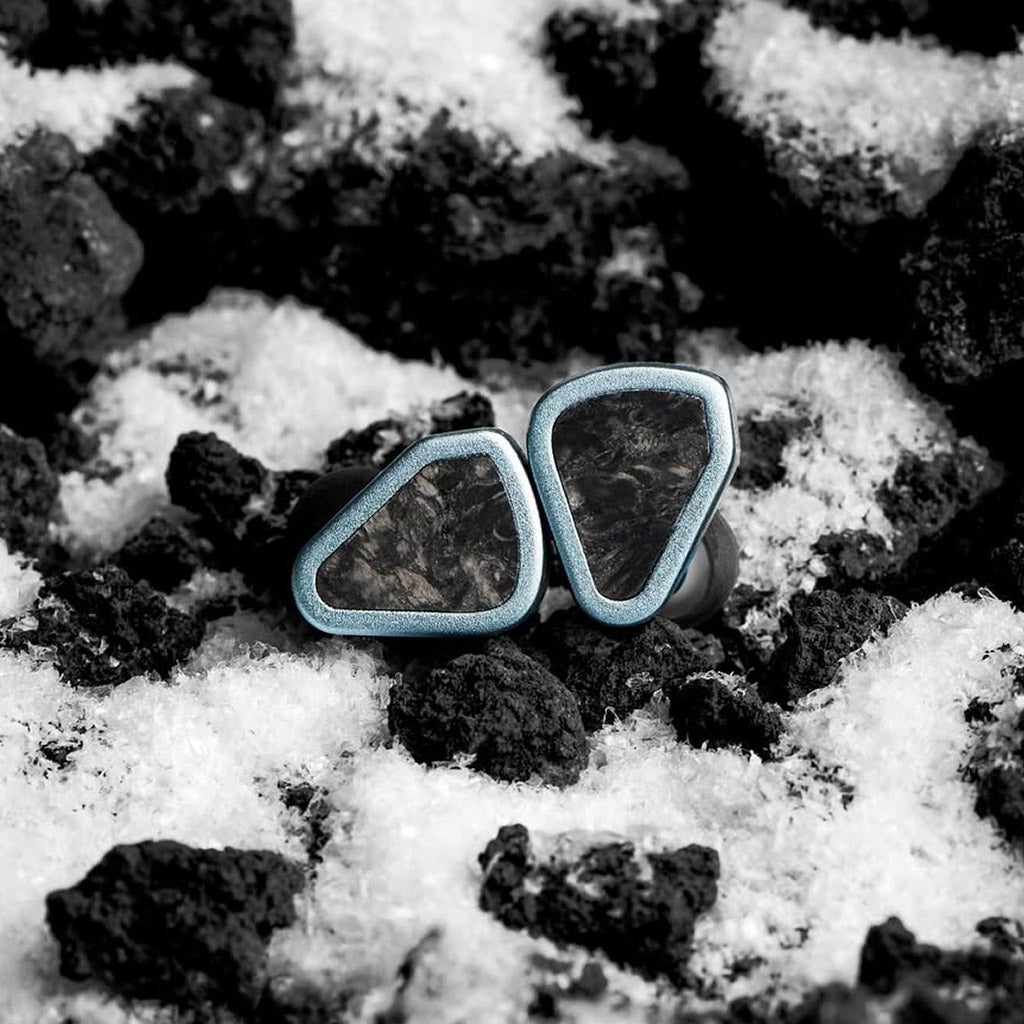 SYMPHONIUM Audio- Giant IEM (Launch Edition) resting on volcanic rock and snow, symbolizing its powerful and immersive sound signature.