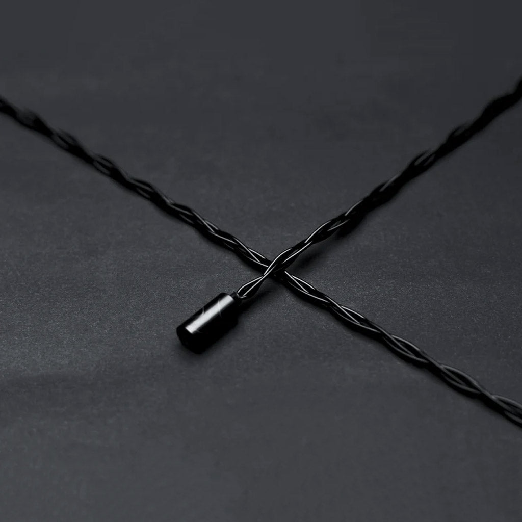 High-quality twisted black audio cable compatible with SYMPHONIUM Audio- Giant IEM (Launch Edition) for optimal signal transmission.