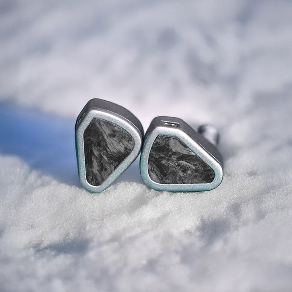 SYMPHONIUM Audio- Giant IEM (Launch Edition) placed on snow, reflecting its Jotunheim-inspired design and rugged premium build.
