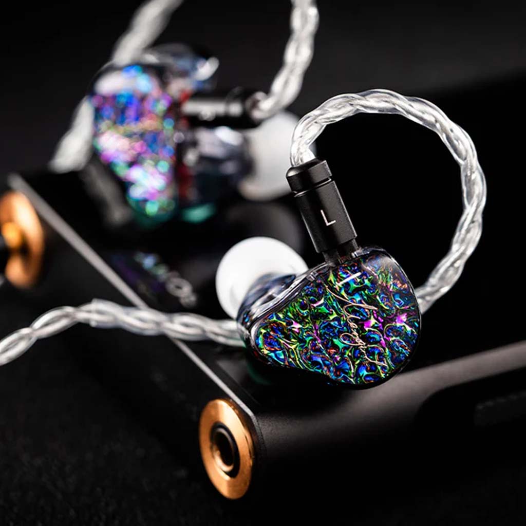 Mangird Top Pro IEM connected to audio device, featuring braided cable and colorful shell for audiophile-grade sound experience.