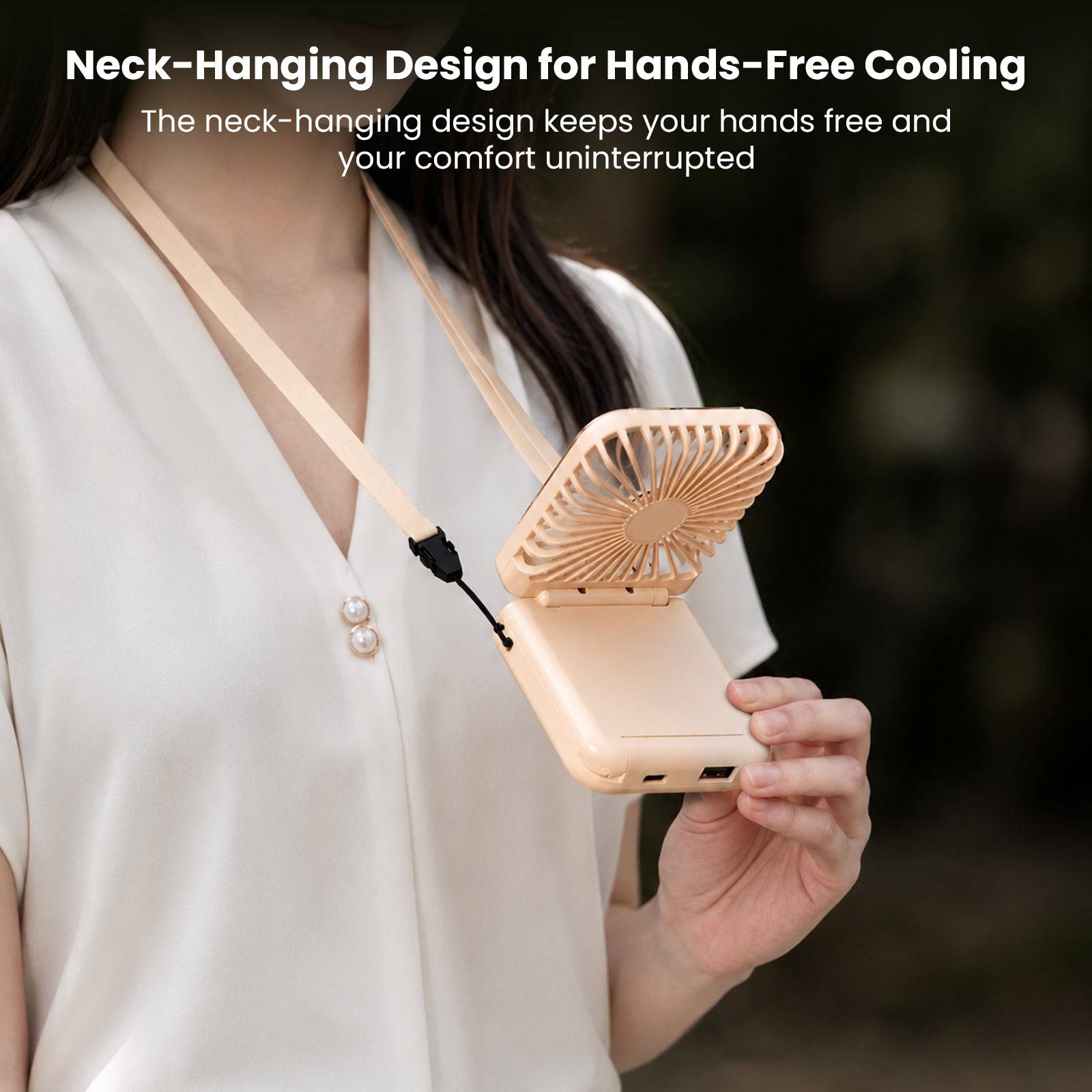 Beige portable fan with neck-hanging strap, compact size, designed for hands-free cooling, shown worn around neck