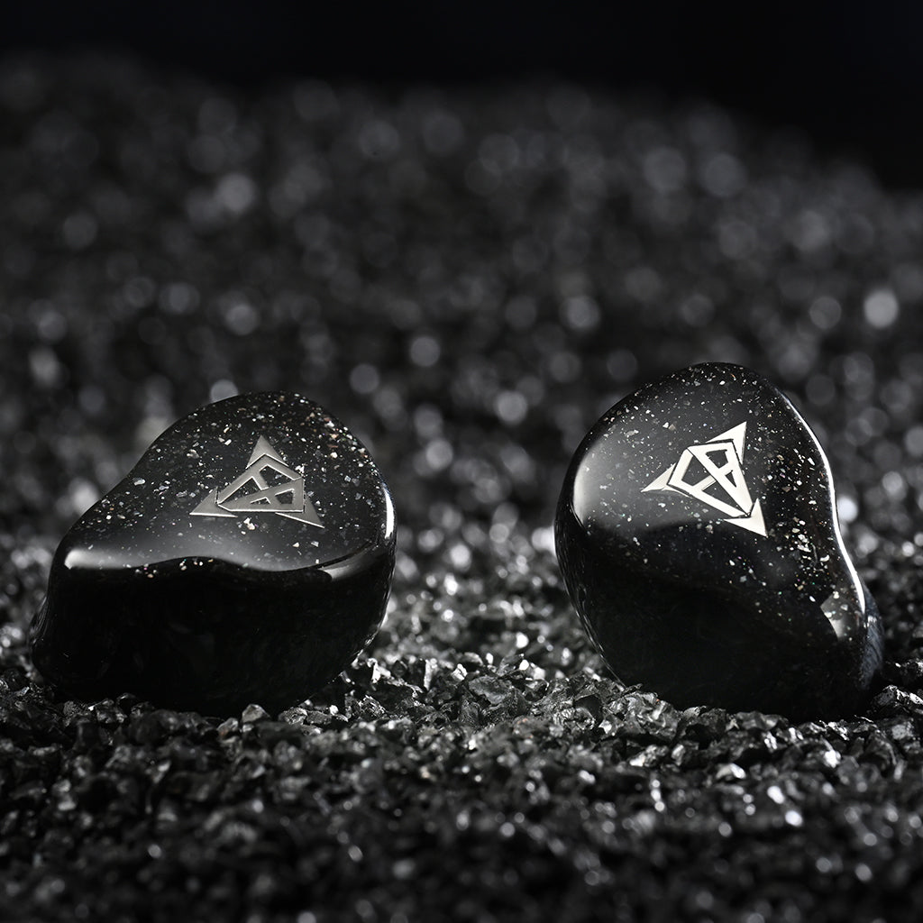 Close-up of Hisenior Mega7 IEMs featuring sleek black shells with silver logo, designed for audiophiles and professional musicians.