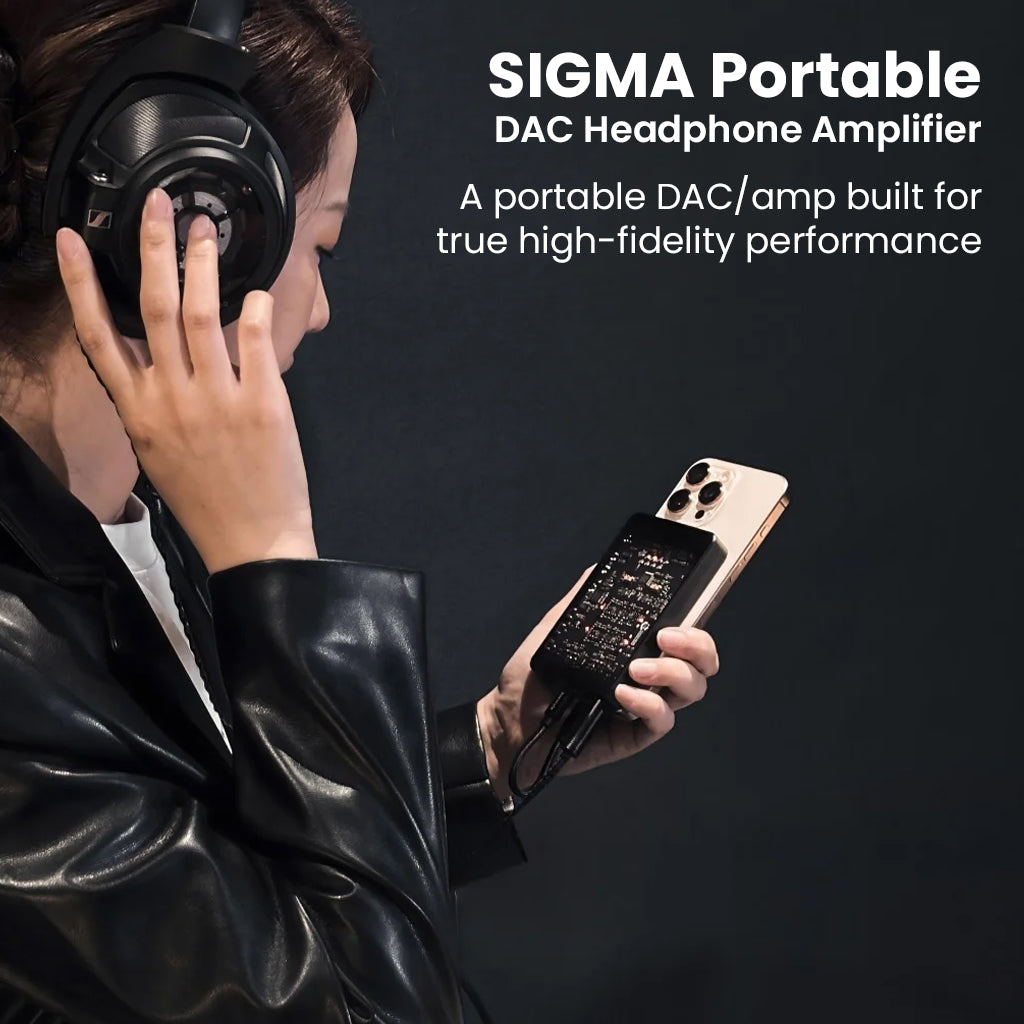 Woman using Questyle Sigma portable DAC and headphone amplifier with smartphone