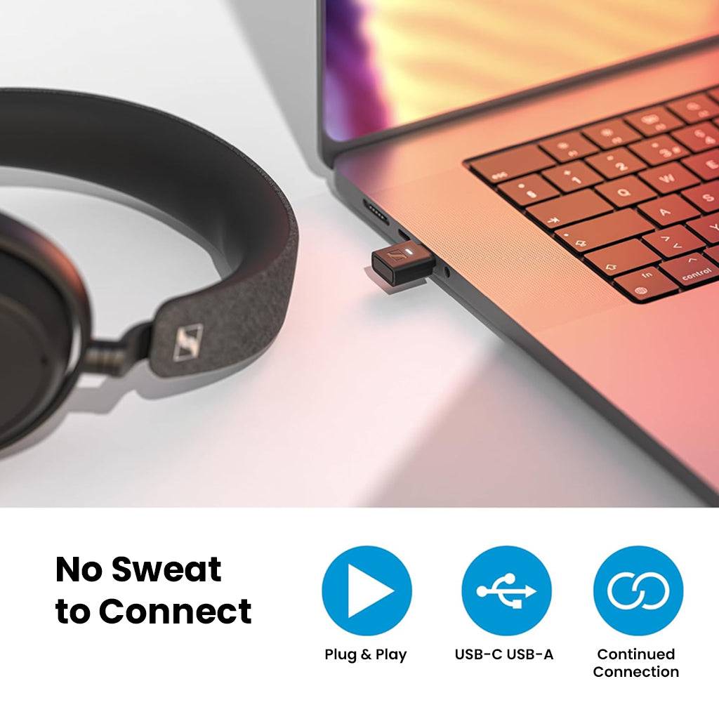 Sennheiser BTD - 700 Bluetooth Dongle plugged into a laptop USB-C port, demonstrating plug-and-play functionality with headphones nearby.