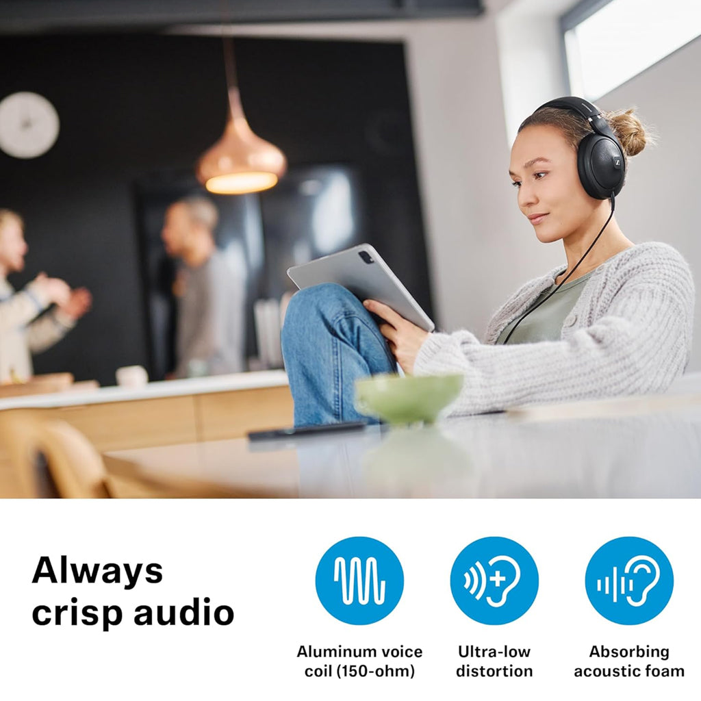 Woman using Sennheiser HD 620S headphones with a tablet, showcasing crisp audio via aluminum voice coil, low distortion, and acoustic foam.