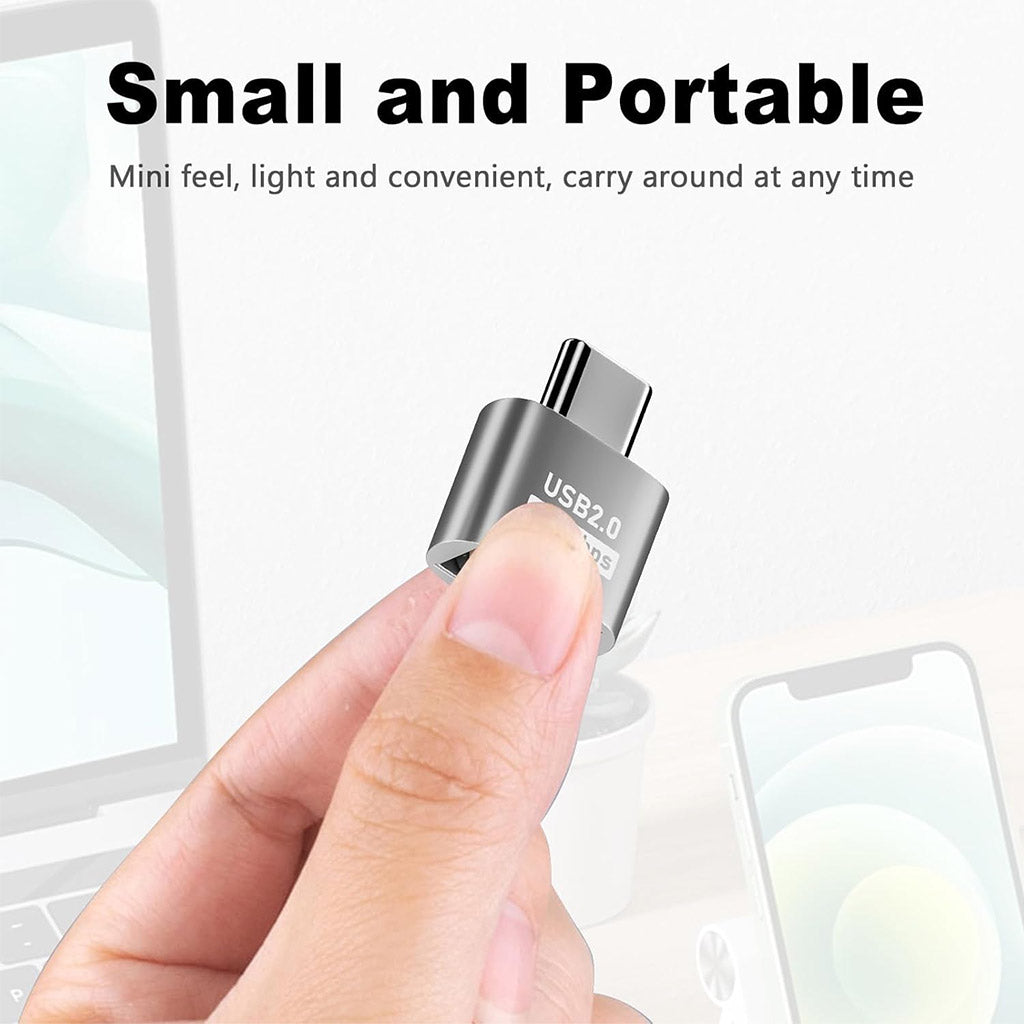 Compact and portable TECPHILE USB Type-C to USB A Adapter held between fingers, ideal for travel and daily use with laptops and phones.
