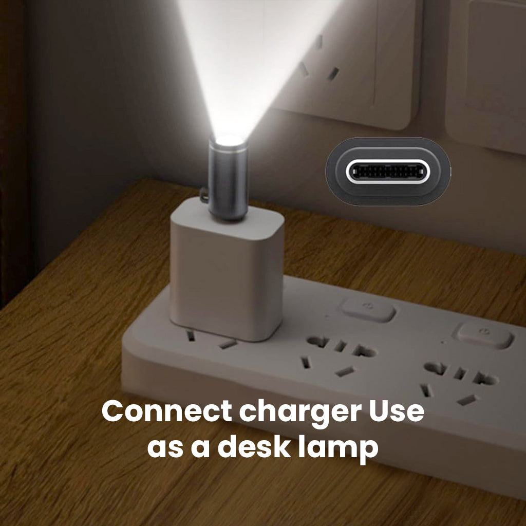 TECPHILE USB-C Mini Flashlight Adapter used as a desk lamp when connected to a charger, providing hands-free lighting in compact spaces.