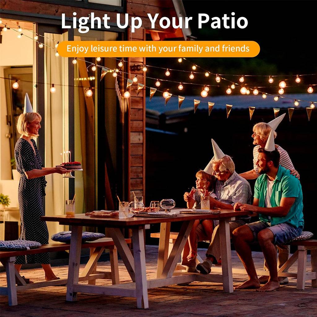 TECPHILE G40 warm white string lights illuminating a patio party, creating a cozy atmosphere for family gatherings and outdoor dining.