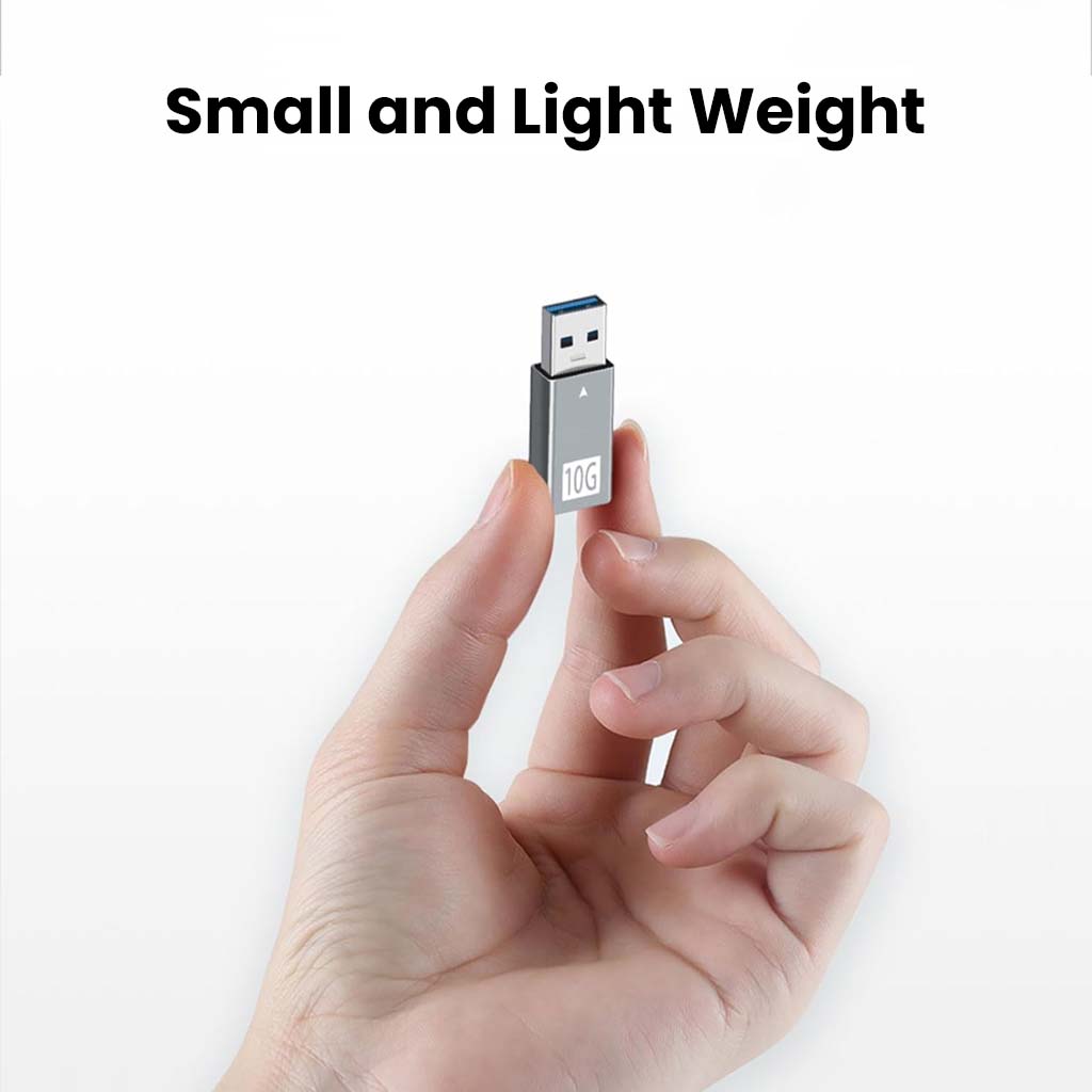 Compact and lightweight TECPHILE USB-C to USB-A Adapter shown held between fingers, ideal for portable laptop connectivity.