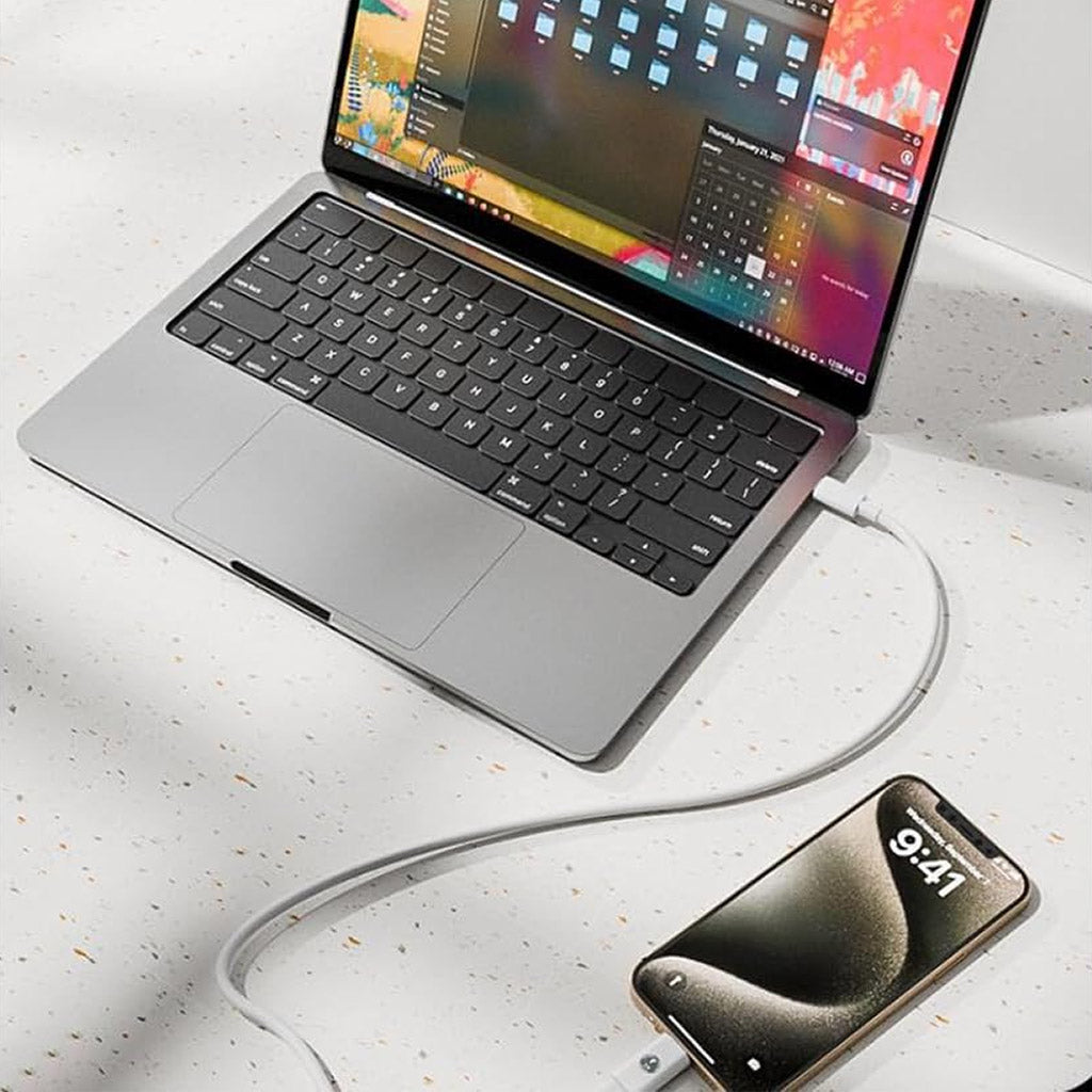 TECPHILE USB-C to Lightning Adapter used to charge iPhone via MacBook. Efficient data transfer and charging for Apple devices.