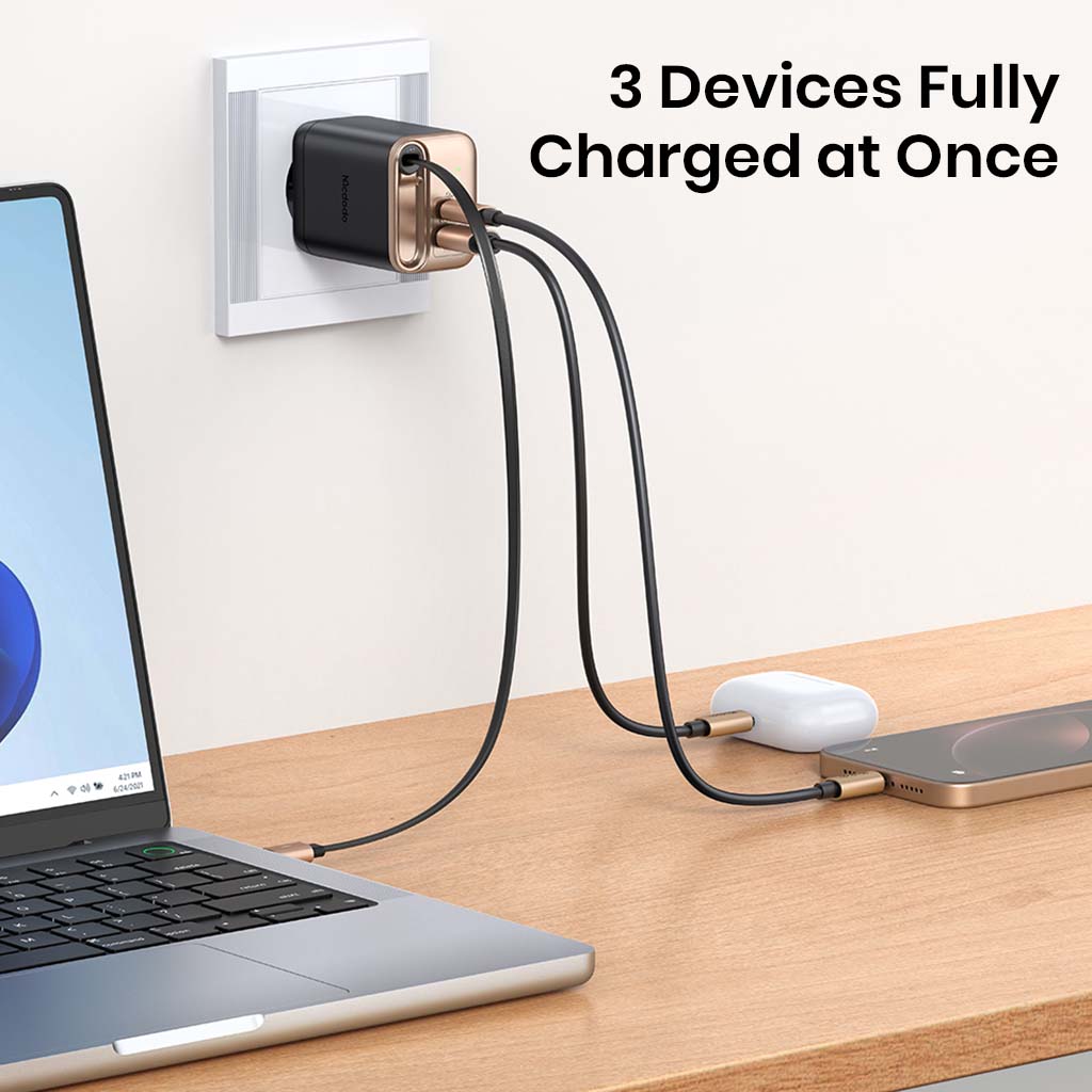 Mcdodo 40W GaN Charger charging three devices simultaneously, including laptop, phone, and earbuds.