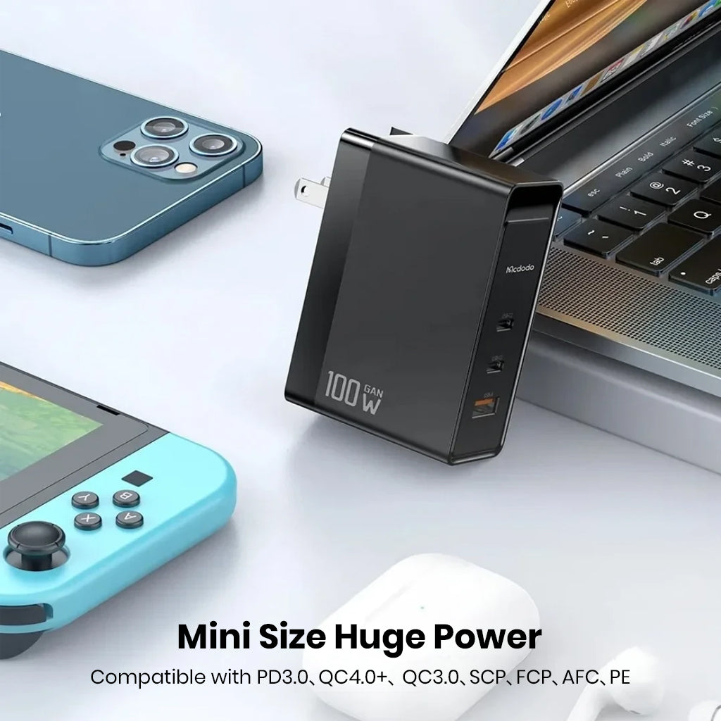 MCDODO 100W GaN charger powering multiple devices including laptop, smartphone, and gaming console with wide compatibility.