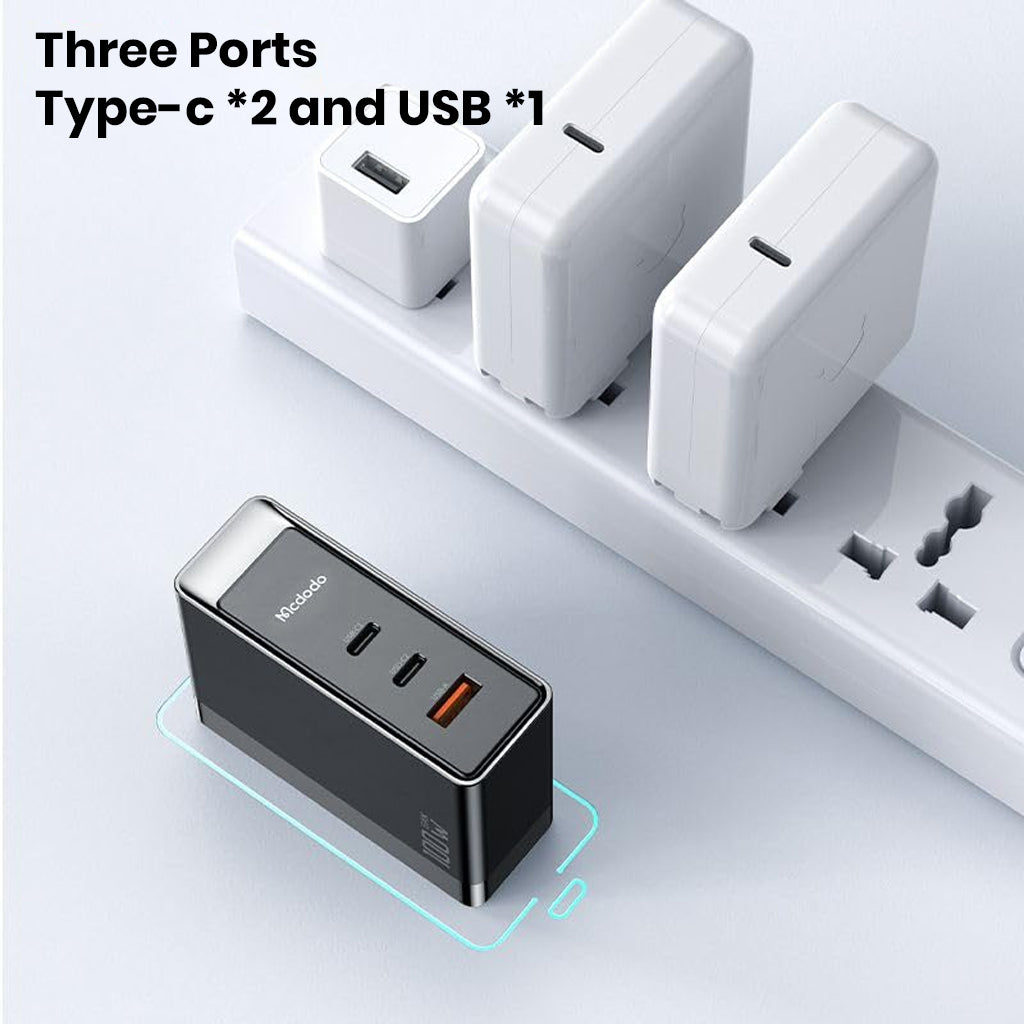 Top view of MCDODO 100W GaN charger showing three ports: two USB-C and one USB-A, designed for simultaneous device charging.
