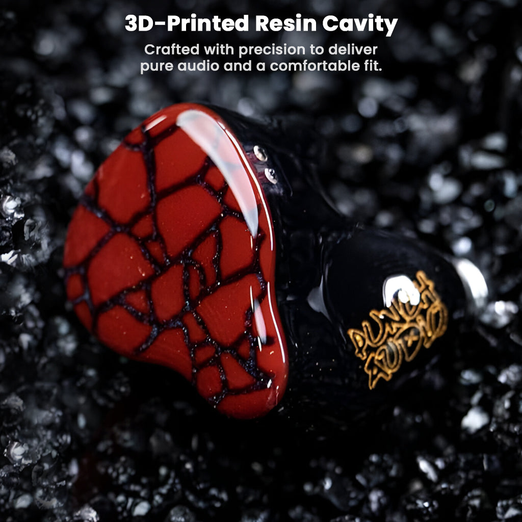 Close-up of Punch Audio Martilo 1 IEM's 3D-printed resin cavity with red cracked faceplate and gold logo, designed for comfort and audio purity.