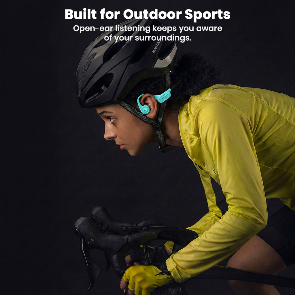 Cyclist wearing teal SHEYIN X5 headphones, designed for outdoor sports with open-ear awareness and secure fit.