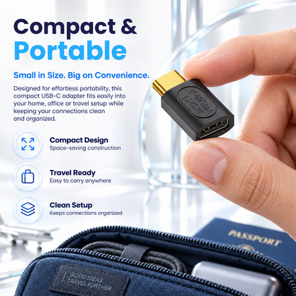 Hand holding a black USB C adapter with gold-plated connector, compact and portable design, suitable for travel, with text overlay