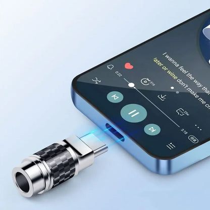 Type-C carbon fiber audio adapter connected to a smartphone, enabling high-quality sound output through a stable and sleek interface.