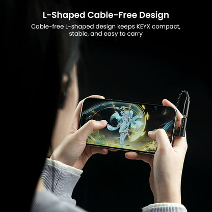 Hands holding a smartphone connected to the compact, L-shaped TRUTHEAR KeyX USB DAC/AMP for high-resolution audio, with gaming visuals on screen