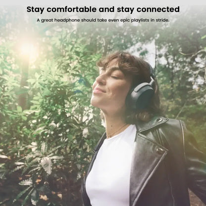 Woman enjoying music outdoors with Sennheiser HDB 630 headphones, highlighting comfort and wireless connectivity.