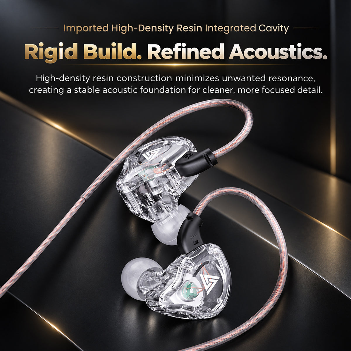 Close-up of a transparent in-ear monitor with a braided pink and white cable, highlighting advanced audio technology for immersive sound.