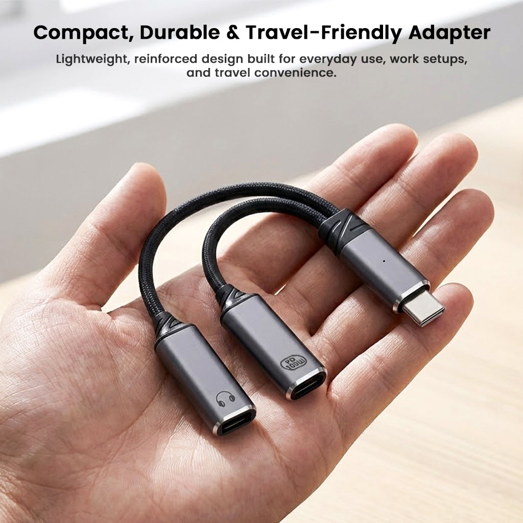 Compact and durable AUDIOCULAR D20 USB-C audio and charging splitter resting on a hand, ideal for travel and everyday use.
