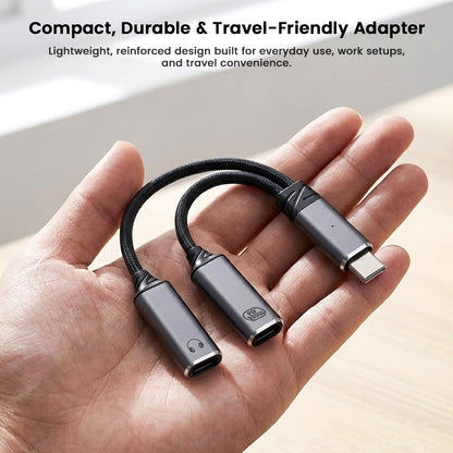 Compact and durable AUDIOCULAR D20 USB-C audio and charging splitter resting on a hand, ideal for travel and everyday use.