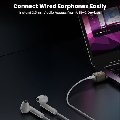 AUDIOCULAR USB-C to 3.5mm Adapter connecting wired earphones to a laptop, enabling instant audio access from USB-C ports.