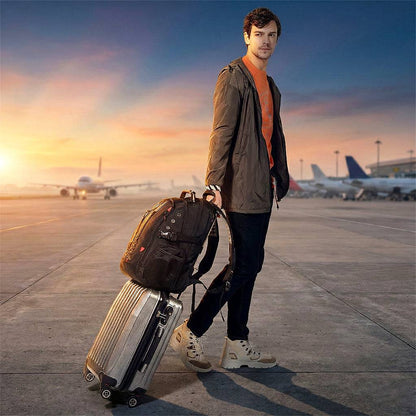 Traveler holding BANGE 1903 backpack attached to suitcase at airport, showcasing its travel-friendly design and portability.