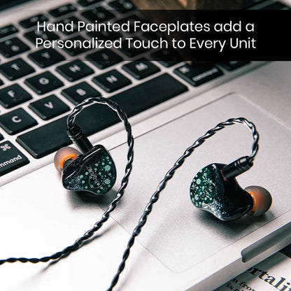 ZiiGaat Arcanis IEM with hand-painted faceplates resting on a laptop, emphasizing its artistic design and premium craftsmanship.