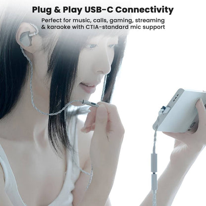 User using Moondrop FreeDSP Mini USB-C DAC with smartphone and earphones, ideal for music, gaming, and streaming with mic support.