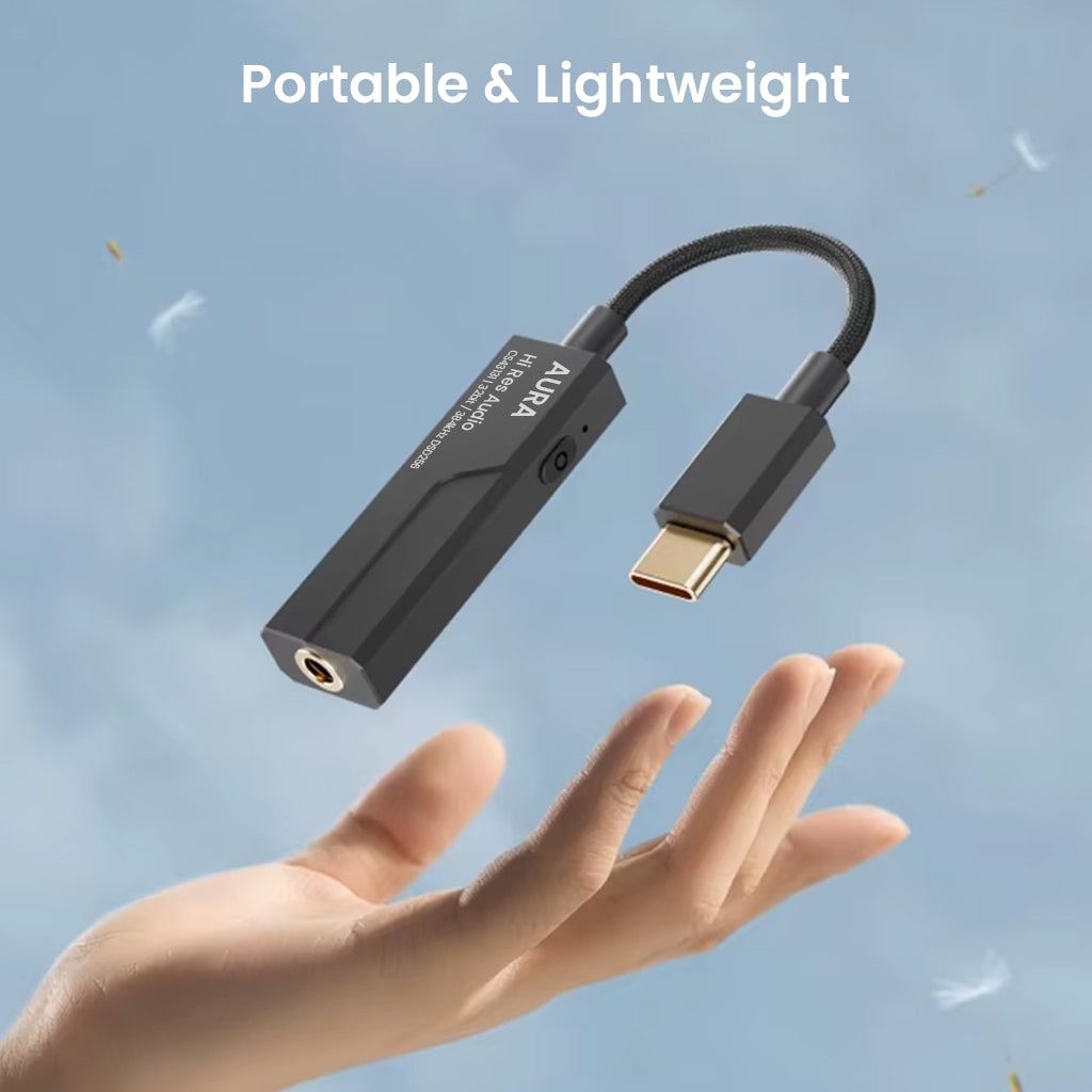 AUDIOCULAR AURA Hi-Res DAC & Amp floating above hand, emphasizing its lightweight and portable design for on-the-go high-resolution audio.