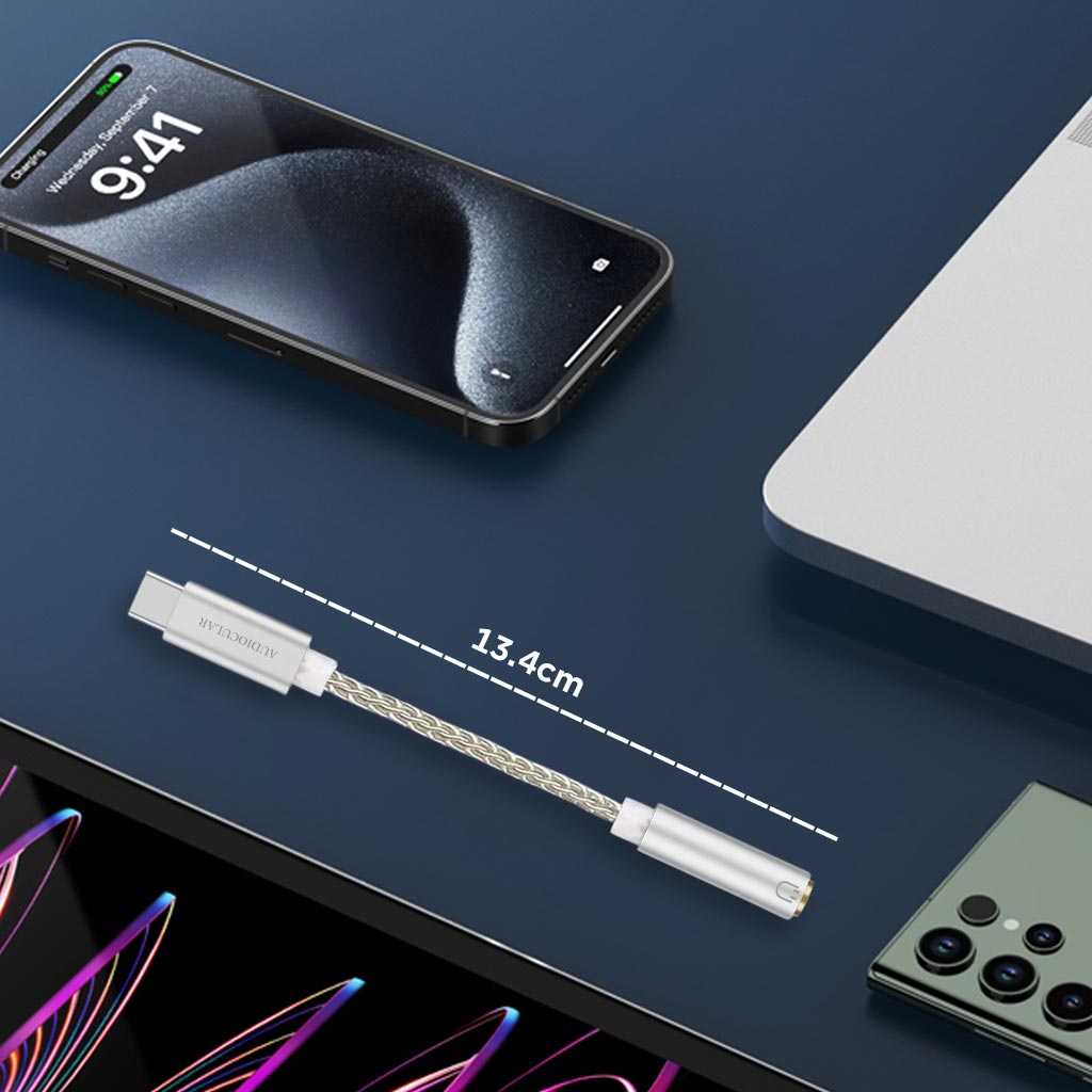 AUDIOCULAR D10 DAC Dongle displayed on desk with smartphone and laptop, measuring 13.4cm for portable high-res audio use.