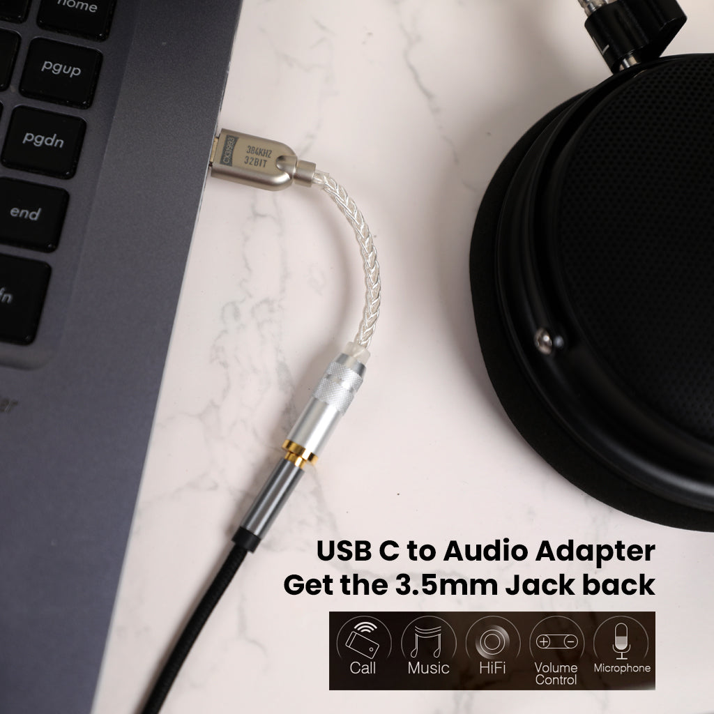 AUDIOCULAR D10 DAC Dongle connected to laptop via USB-C, restoring 3.5mm jack functionality for headphones and audio accessories.