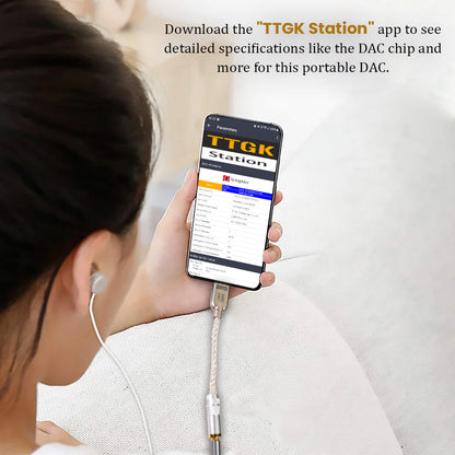User checking TTGK Station app on phone while using AUDIOCULAR D10 DAC Dongle to view detailed DAC chip specifications.