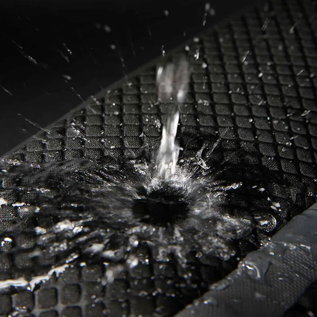 Water-resistant surface of BANGE 7710 leather backpack repelling water, ensuring laptop and gear stay dry in wet conditions.