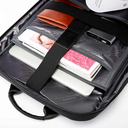 Organized interior of BANGE 7710 leather laptop backpack with compartments for laptop, wallet, and tech accessories.