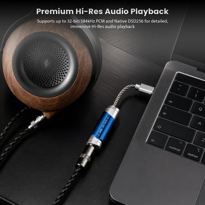 DUNU DTC 100 Pro portable USB DAC & amp with blue aluminum body, silver accents, and braided cable connected to a laptop