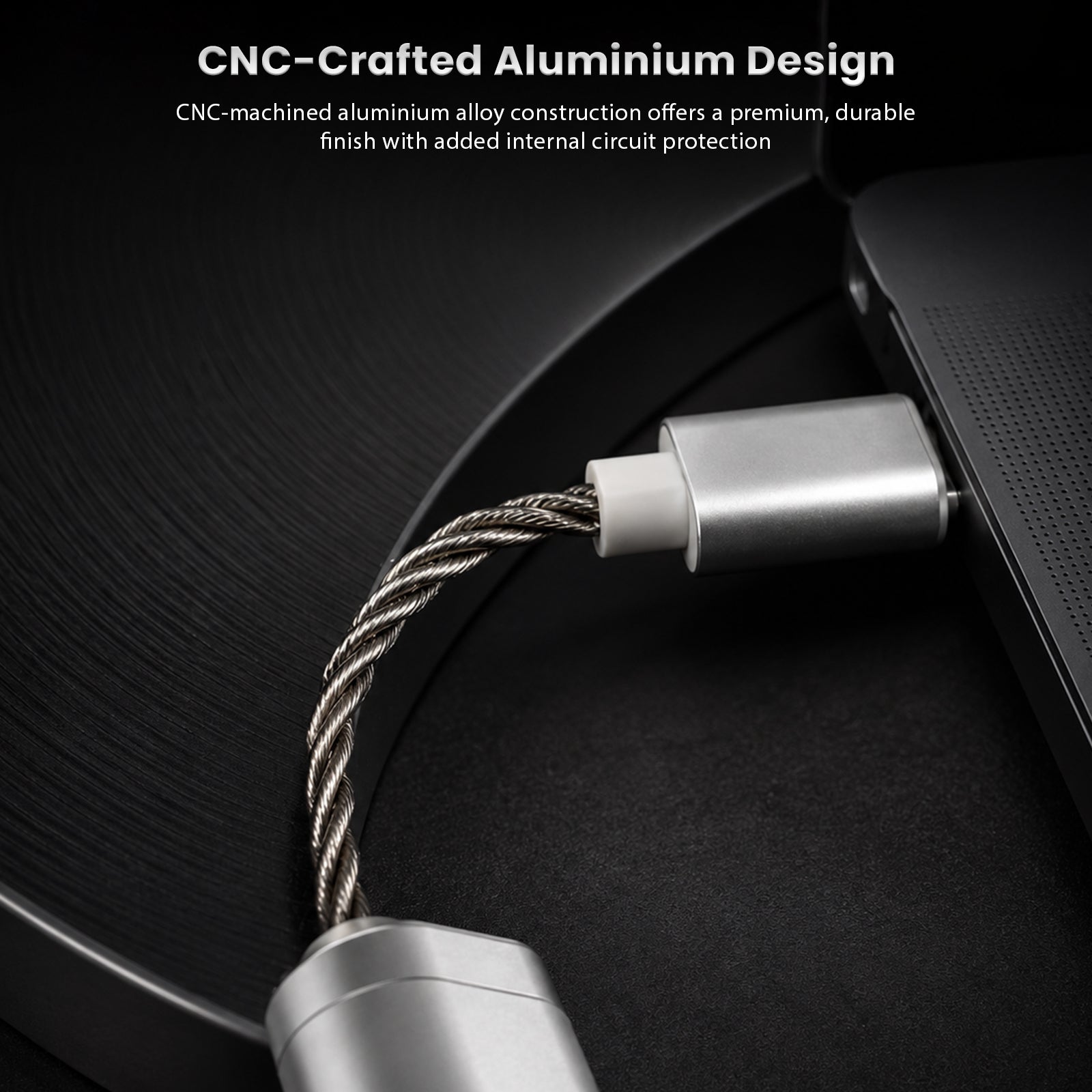 Close-up of the DUNU DTC 100 Pro portable USB DAC & amp with CNC-machined aluminum body, silver and blue finish, and braided cable connection