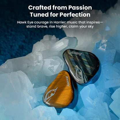 JUZEAR Harrier IEMs resting on crystals, showcasing bold design and audiophile-grade tuning for immersive listening.