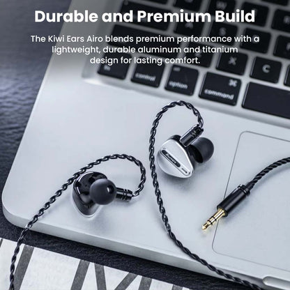 Kiwi Ears Airoso IEM placed on a laptop, showcasing its premium aluminum and titanium build for durability and long-lasting comfort.