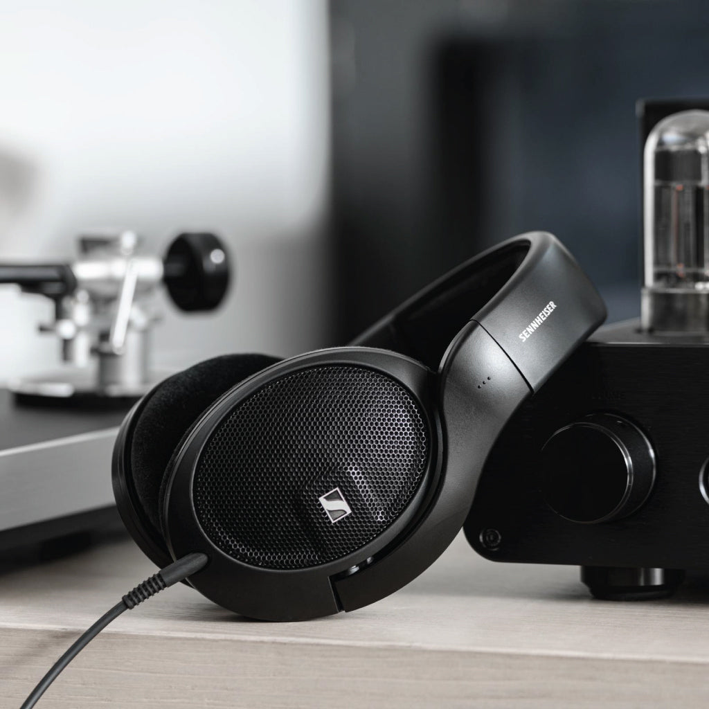 Sennheiser HD 560S wired headphones resting beside audio equipment, emphasizing their use for critical listening and reference-grade sound.
