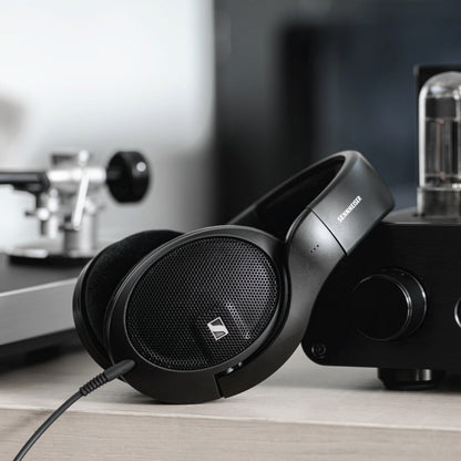 Sennheiser HD 560S wired headphones resting beside audio equipment, emphasizing their use for critical listening and reference-grade sound.