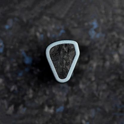 Close-up of a single SYMPHONIUM Audio- Giant IEM (Launch Edition) showcasing its unique triangular design and textured faceplate.