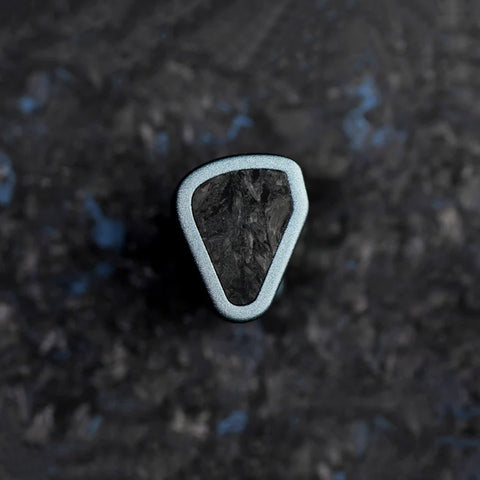 Close-up of a single SYMPHONIUM Audio- Giant IEM (Launch Edition) showcasing its unique triangular design and textured faceplate.